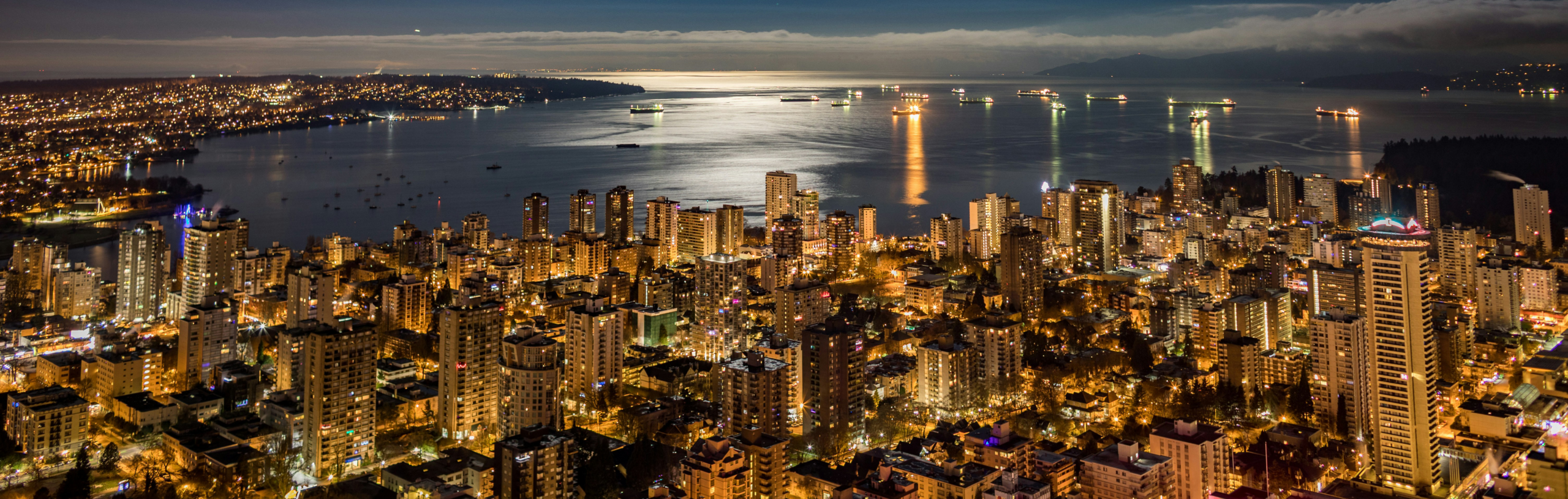 Night view of downtown Vancouver near The Sunset, with city lights and waterfront