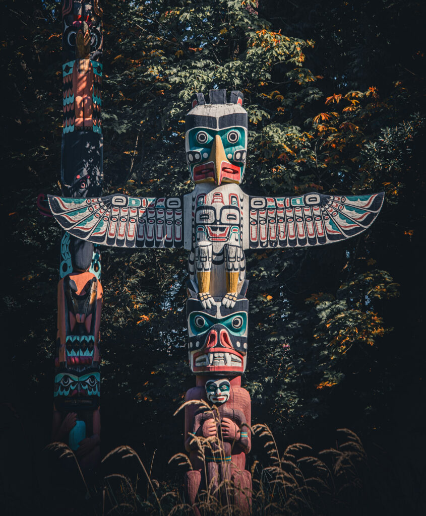 Totem poles at Brockton Point in Stanley Park Vancouver surrounded by coastal forest